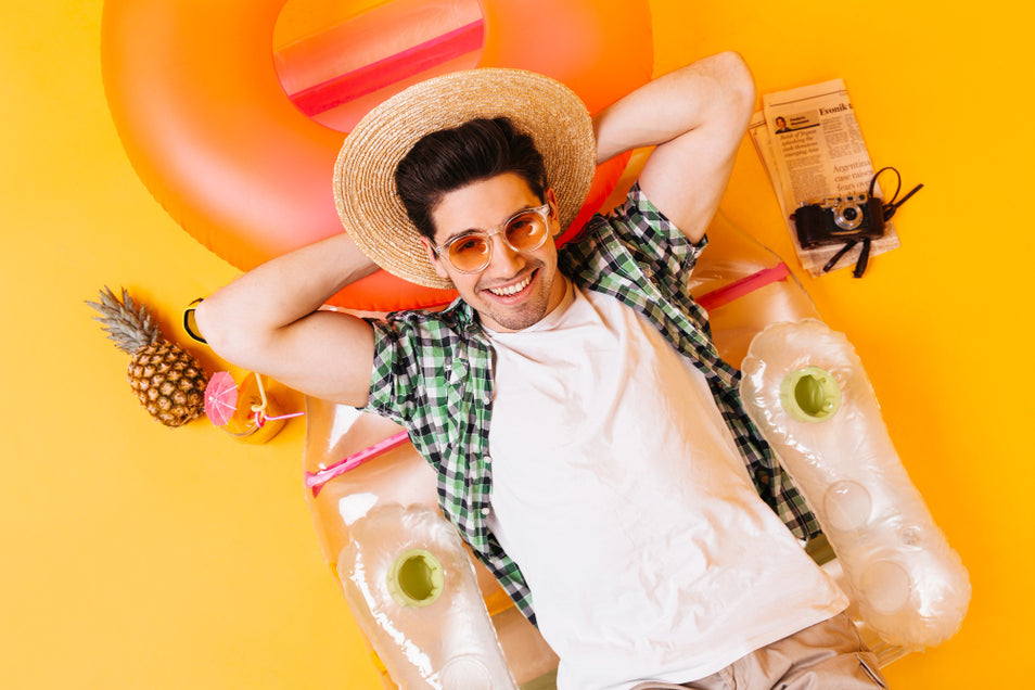 man smiling and happy during summer while protecting his beard